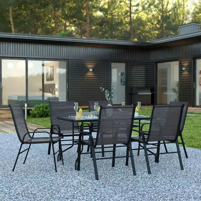 Ensemble de table de patio sept pièces Emma et Oliver avec table en métal avec plateau en verre trempé et 6 chaises empilables Flex Comfort